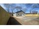 Spacious backyard featuring a newly installed fence and a concrete driveway at 702 E Grover St, Shelby, NC 28150