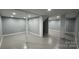 Spacious basement featuring painted concrete flooring, white trim, and supportive columns at 702 E Grover St, Shelby, NC 28150