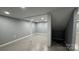Finished basement featuring painted concrete floors, painted brick columns, and gray walls at 702 E Grover St, Shelby, NC 28150