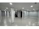 Finished basement featuring painted concrete floors, painted brick columns, and access to stairs at 702 E Grover St, Shelby, NC 28150