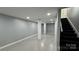 Finished basement with painted brick columns, carpeted stairs, gray walls and concrete floors at 702 E Grover St, Shelby, NC 28150