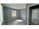 Light and airy bedroom showcasing hardwood floors and neutral gray paint at 702 E Grover St, Shelby, NC 28150