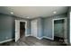 Bedroom featuring gray walls, trim detail, and wood-look flooring for a modern, stylish look at 702 E Grover St, Shelby, NC 28150