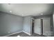 Bedroom with hardwood floors and recessed lighting, next to a double-door closet at 702 E Grover St, Shelby, NC 28150