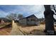Exterior view of a single-story home featuring a front porch and freshly painted exterior at 702 E Grover St, Shelby, NC 28150