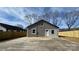 Exterior view of a single-story home featuring a newly installed fence and a concrete driveway at 702 E Grover St, Shelby, NC 28150
