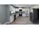 Well-lit kitchen with stainless steel appliances, granite countertops, and sleek white cabinetry at 702 E Grover St, Shelby, NC 28150