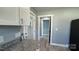 Kitchen with granite countertops, white cabinetry, and access to the backyard through a glass door at 702 E Grover St, Shelby, NC 28150