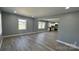Bright and open living room featuring wood floors, fresh paint and a clear view into the kitchen at 702 E Grover St, Shelby, NC 28150