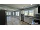 Bright open-concept living room with many windows providing natural light at 702 E Grover St, Shelby, NC 28150