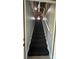 Ascending carpeted stairway illuminated with natural light from the upper level at 702 E Grover St, Shelby, NC 28150