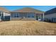 Exterior view of the back of the home and the screened in patio at 758 Latrobe Dr, Iron Station, NC 28080