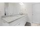 Well-lit bathroom features double sinks with granite counters and white cabinets at 758 Latrobe Dr, Iron Station, NC 28080