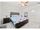 Spacious bedroom with a large bed, carpet flooring, and a ceiling fan at 758 Latrobe Dr, Iron Station, NC 28080