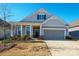 Charming home featuring a two-car garage, covered porch, and professionally landscaped front yard at 758 Latrobe Dr, Iron Station, NC 28080