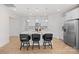 Kitchen showcases a quartz island with seating, white cabinets, stainless appliances, and ample counter space at 758 Latrobe Dr, Iron Station, NC 28080