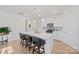 Lovely kitchen featuring white cabinetry, stainless appliances, kitchen island with stools, and backsplash at 758 Latrobe Dr, Iron Station, NC 28080