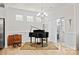 Elegant living room featuring a hardwood floor, natural light, and a piano at 758 Latrobe Dr, Iron Station, NC 28080