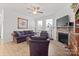 Cozy living room with a stone fireplace, a ceiling fan, and comfortable seating at 758 Latrobe Dr, Iron Station, NC 28080