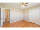 This bedroom features hardwood floors, a ceiling fan, closet and an adjacent bathroom at 839 Oak Grove Rd, Kings Mountain, NC 28086