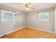 This bedroom features hardwood floors, a ceiling fan, and a mirrored wall at 839 Oak Grove Rd, Kings Mountain, NC 28086