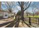 Back deck attached to the house overlooks large backyard with expansive mature trees offering tranquil outdoor living at 839 Oak Grove Rd, Kings Mountain, NC 28086