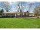 Classic brick ranch home featuring a carport, inviting curb appeal and cozy charm at 839 Oak Grove Rd, Kings Mountain, NC 28086