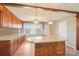 Charming kitchen features wood cabinets, a wraparound peninsula, and pendant lighting at 839 Oak Grove Rd, Kings Mountain, NC 28086
