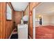 Efficient laundry room with wood paneled walls, washer, dryer, and water heater at 839 Oak Grove Rd, Kings Mountain, NC 28086