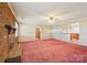 An expansive carpeted living room featuring brick fireplace and access to other rooms at 839 Oak Grove Rd, Kings Mountain, NC 28086