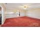 Large living room with neutral walls and red carpet offers flexible layout options at 839 Oak Grove Rd, Kings Mountain, NC 28086