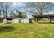 Backyard featuring three sheds and a covered play area with mature trees at 839 Oak Grove Rd, Kings Mountain, NC 28086