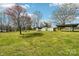 A spacious backyard with multiple sheds and a covered swing-set/play area at 839 Oak Grove Rd, Kings Mountain, NC 28086