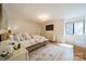 Bright and airy bedroom with a woven platform bed, natural light, and neutral decor at 8911 St Croix Ln, Charlotte, NC 28277