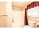 Bathroom featuring a bathtub, shower, and a window with blinds and a curtain at 9027 Mccray Farms Dr, Hickory, NC 28601