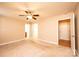 Carpeted bedroom featuring a ceiling fan, base trim, and multiple doorways at 9027 Mccray Farms Dr, Hickory, NC 28601