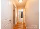 Hallway with hardwood floors and multiple doorways to different rooms at 9027 Mccray Farms Dr, Hickory, NC 28601