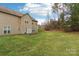 Exterior of home features a traditional backyard, a wood deck, and manicured grass at 9391 Leyton Dr, Harrisburg, NC 28075