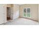 Bedroom featuring neutral walls, carpet flooring, and a window for natural light at 9391 Leyton Dr, Harrisburg, NC 28075