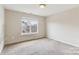 Bedroom featuring neutral walls, carpet flooring, and a window for natural light at 9391 Leyton Dr, Harrisburg, NC 28075