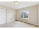 A carpeted bedroom is brightened by a window and features neutral walls at 9391 Leyton Dr, Harrisburg, NC 28075