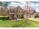Beautiful two-story brick home with green lawn, flower beds and two-car garage at 9391 Leyton Dr, Harrisburg, NC 28075
