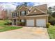 Charming two-story brick home featuring a two-car garage, and landscaped yard at 9391 Leyton Dr, Harrisburg, NC 28075