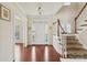 Welcoming foyer with hardwood floors, a staircase, and natural light at 9391 Leyton Dr, Harrisburg, NC 28075
