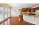 Open kitchen and dining area with granite countertops, dark cabinets and hardwood floors at 9391 Leyton Dr, Harrisburg, NC 28075