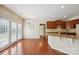 Kitchen and dining area with hardwood floors, and dark cabinets at 9391 Leyton Dr, Harrisburg, NC 28075