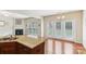 Open kitchen area with granite countertops and stainless steel sink overlooking dining area at 9391 Leyton Dr, Harrisburg, NC 28075