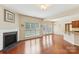 Bright living room with fireplace, large windows, and hardwood floors at 9391 Leyton Dr, Harrisburg, NC 28075