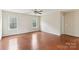 Spacious living room featuring hardwood floors, windows, and a ceiling fan at 9391 Leyton Dr, Harrisburg, NC 28075