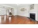 Spacious living room with hardwood floors, fireplace, and staircase at 9391 Leyton Dr, Harrisburg, NC 28075